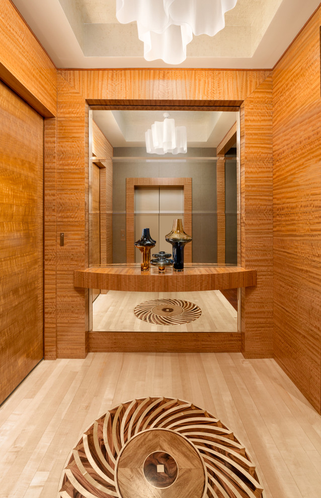 Example of a beach style light wood floor entry hall design in Miami with brown walls