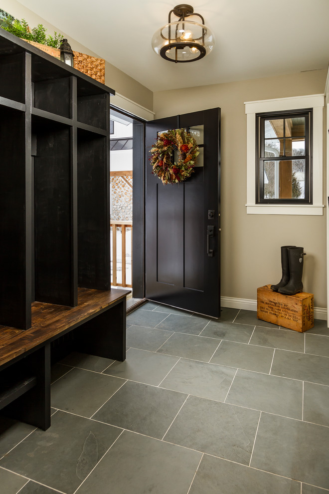 Photo of a medium sized farmhouse boot room in Minneapolis with grey walls, slate flooring, a black front door, blue floors and feature lighting.