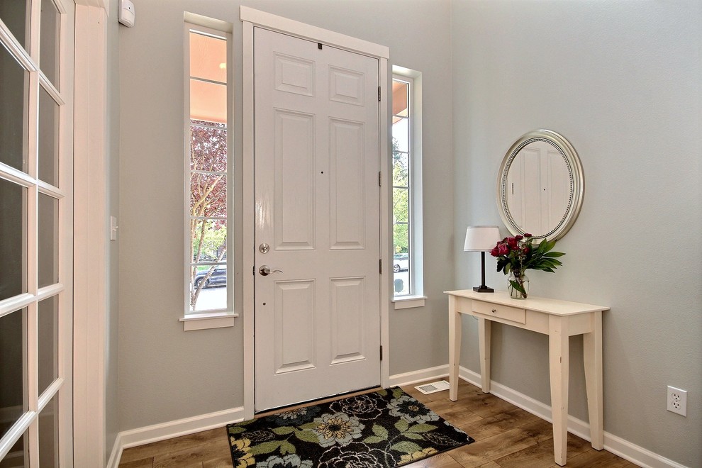 Small transitional light wood floor front door photo in Seattle with gray walls