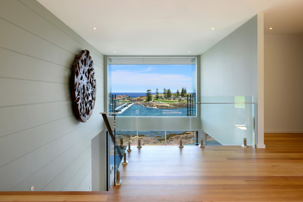 Photo of a medium sized modern foyer in Wollongong with white walls, medium hardwood flooring, a single front door and a medium wood front door.