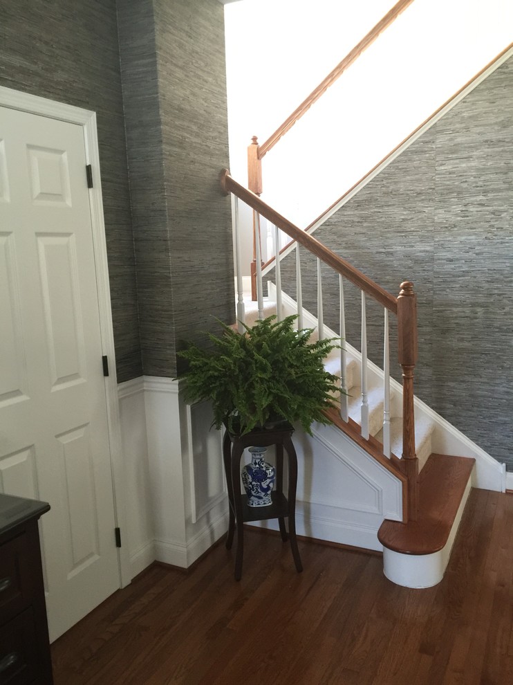 Example of a mid-sized transitional medium tone wood floor foyer design in Philadelphia with gray walls