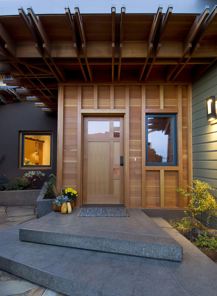 Photo of a contemporary front door in Seattle with a single front door and a medium wood front door.
