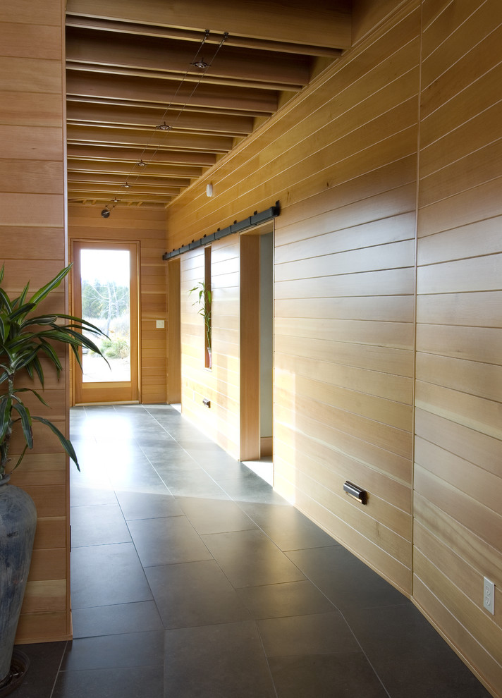 Example of a trendy entryway design in Seattle with beige walls and a glass front door