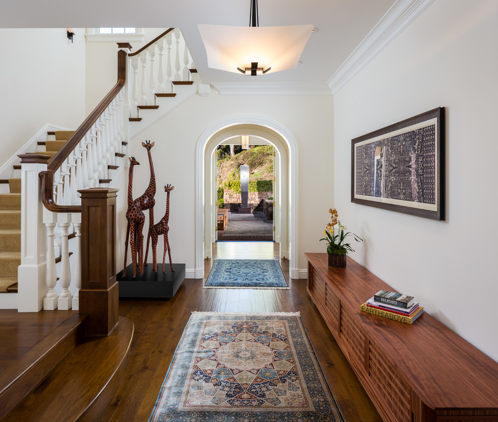 Inspiration for an expansive classic foyer in San Francisco with white walls, medium hardwood flooring, a single front door, a black front door and brown floors.
