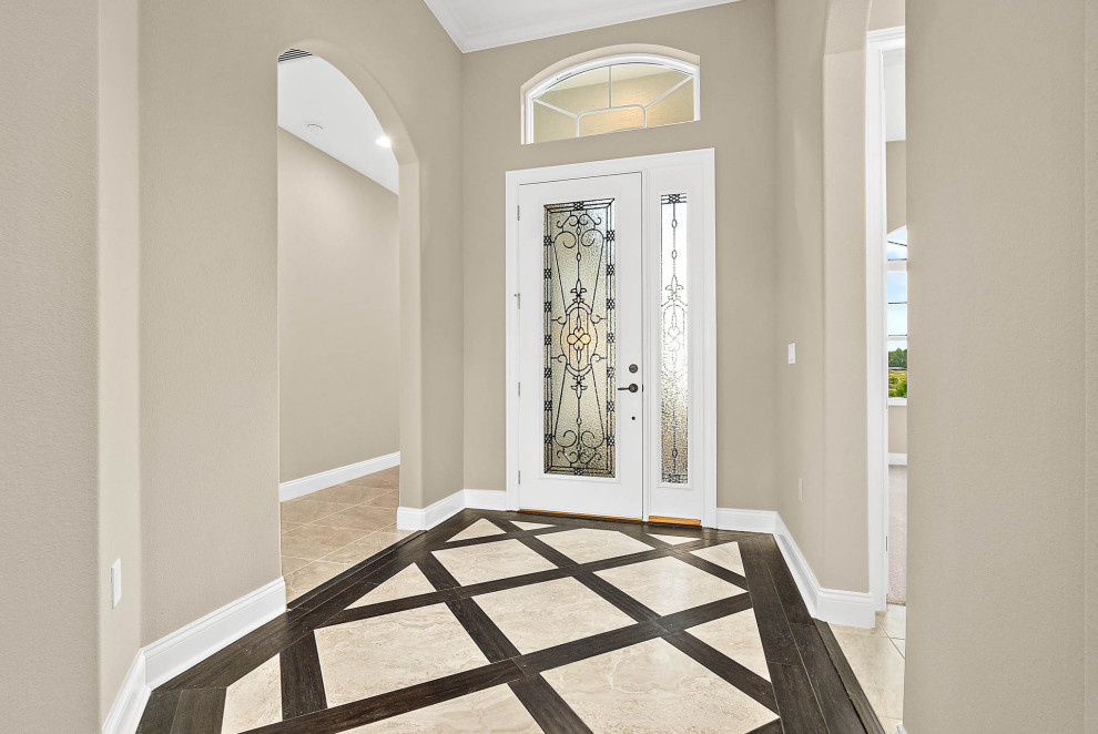 Ejemplo de puerta principal tradicional renovada grande con paredes beige, puerta simple, puerta de vidrio, suelo de baldosas de cerámica y suelo beige