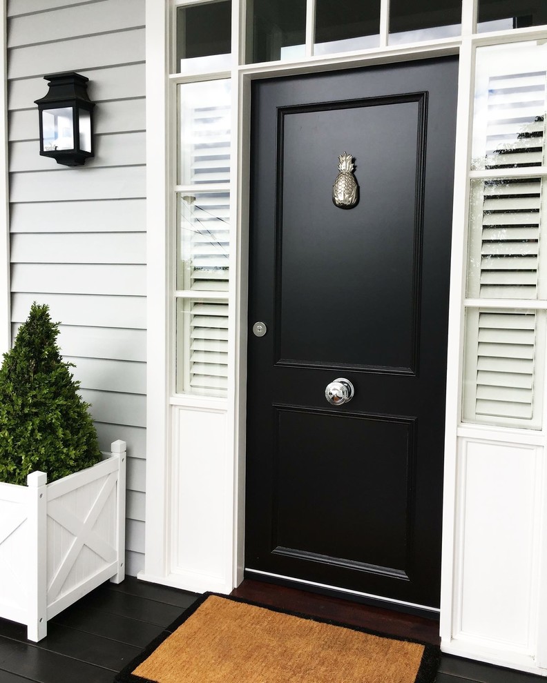 Inspiration for a modern single front door remodel in Providence with a black front door