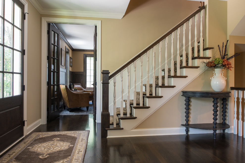 Photo of a medium sized traditional foyer in Minneapolis with beige walls, dark hardwood flooring, a single front door, a glass front door and brown floors.