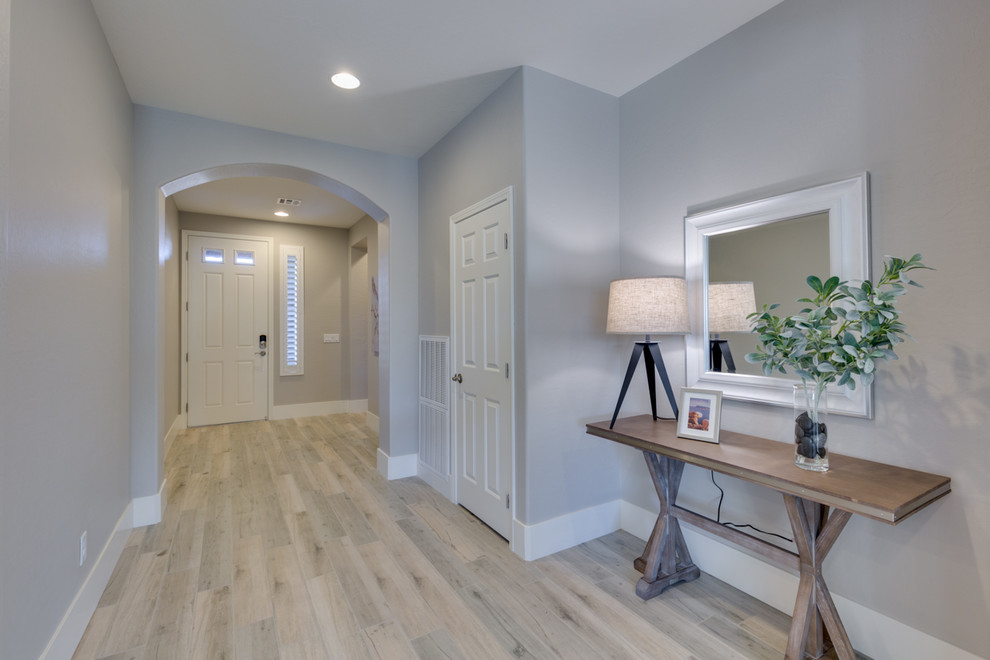 Photo of a small classic foyer in Las Vegas with grey walls, porcelain flooring, a single front door, a brown front door and multi-coloured floors.