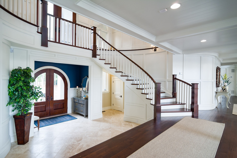Classic foyer in Other with white walls, a double front door, a dark wood front door and beige floors.