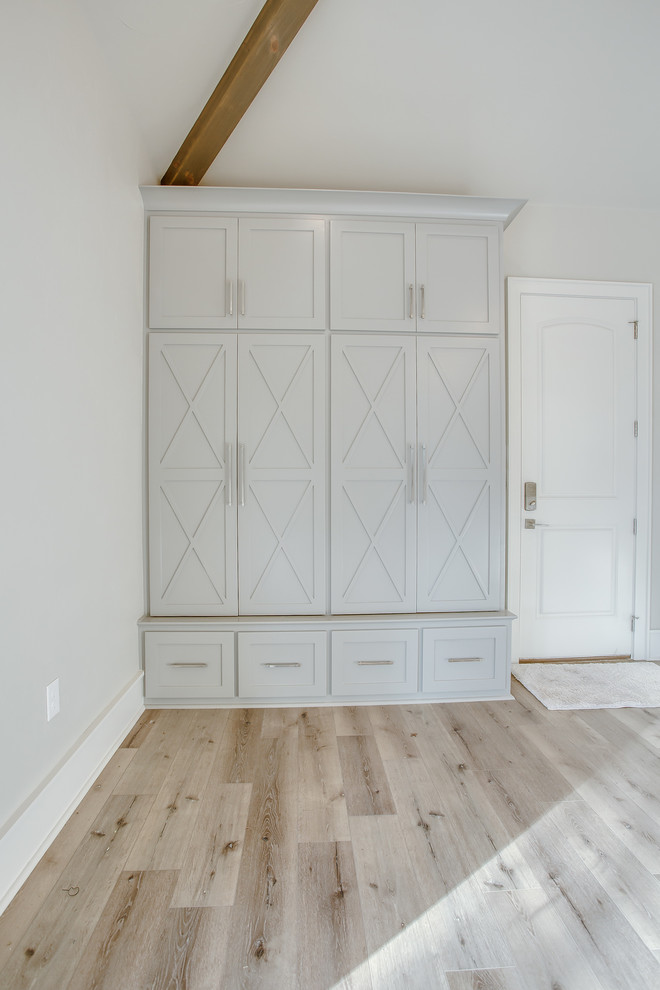 Modern inredning av en mellanstor ingång och ytterdörr, med grå väggar, ljust trägolv, en enkeldörr, en vit dörr och beiget golv