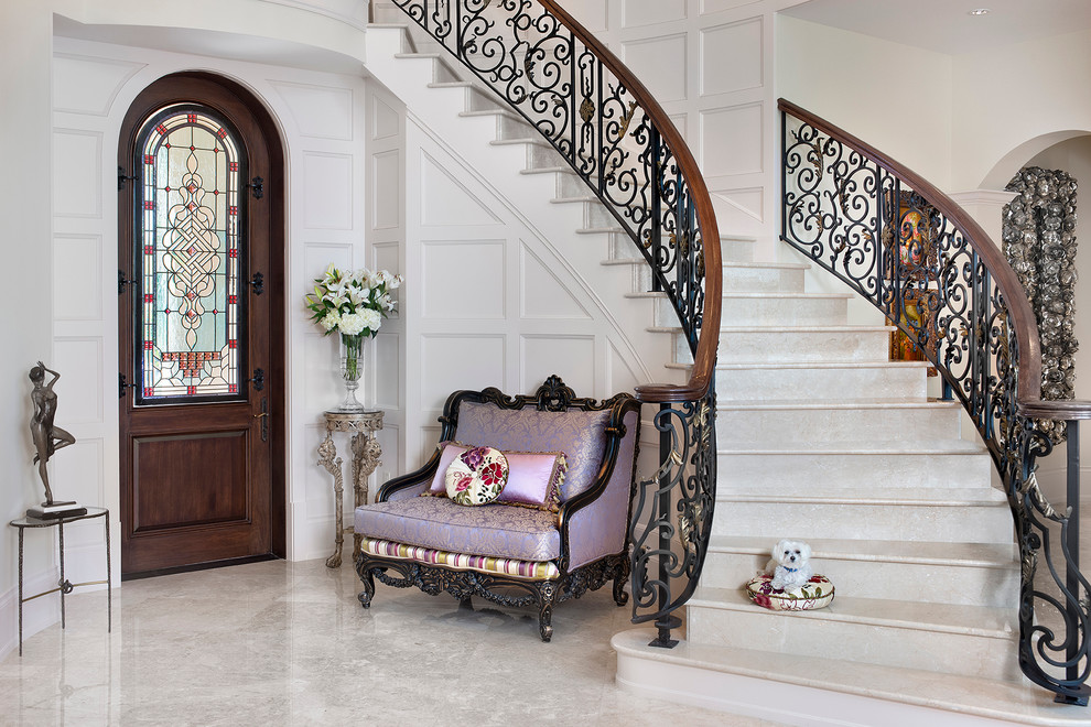 Photo of a bohemian foyer in Miami with white walls, marble flooring, a single front door and a dark wood front door.