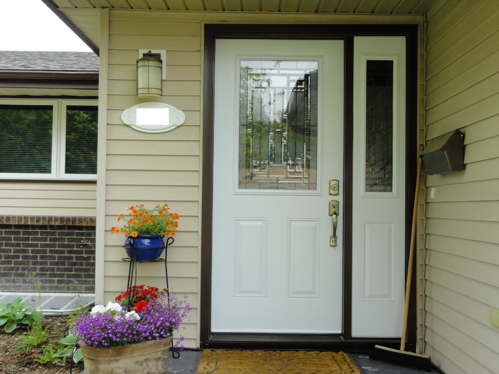 Example of a mid-sized classic entryway design in Calgary with beige walls and a white front door