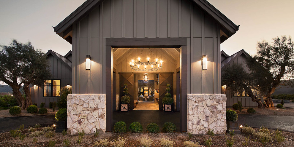 Inspiration for a large farmhouse concrete floor and beige floor entryway remodel in San Francisco with beige walls and a metal front door