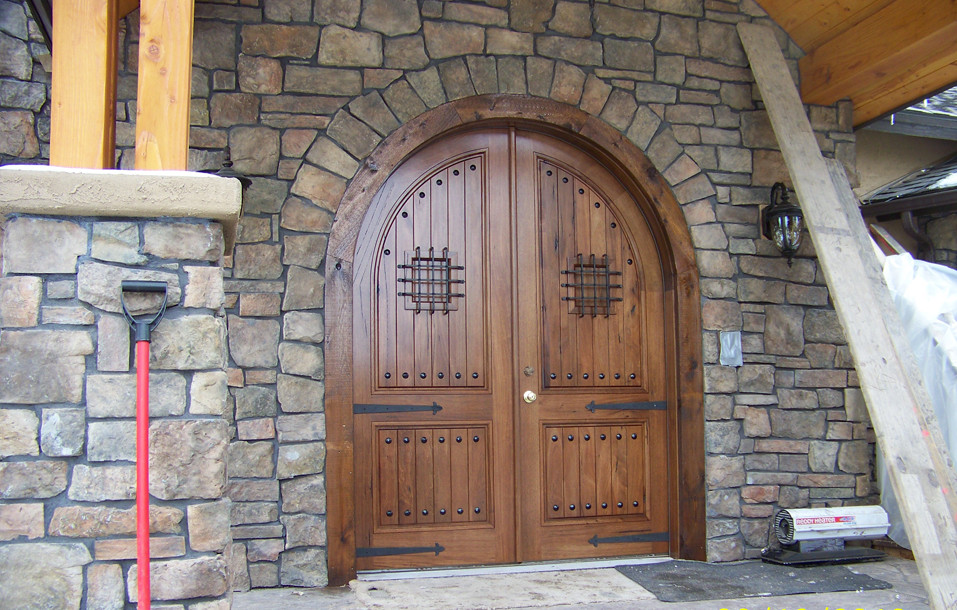 Large rustic front door in Denver with a double front door and a medium wood front door.