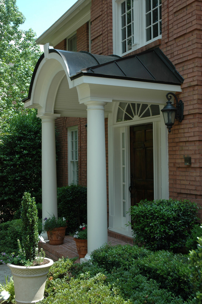 This is an example of a medium sized classic front door in Atlanta with a single front door and a dark wood front door.