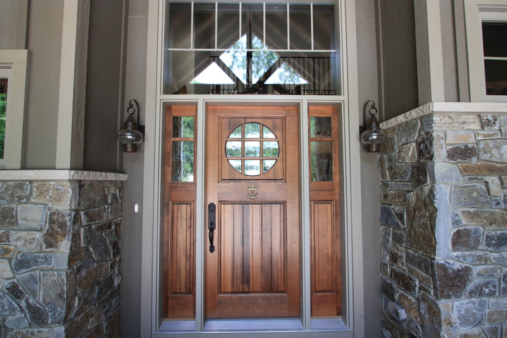 Réalisation d'une porte d'entrée chalet de taille moyenne avec un mur marron, un sol en bois brun, une porte simple et une porte en bois brun.