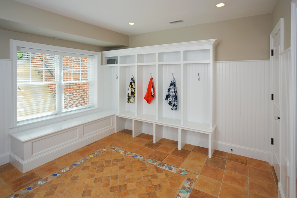 This is an example of a classic boot room in DC Metro with beige walls and porcelain flooring.