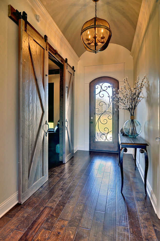 Design ideas for a medium sized traditional hallway in Dallas with beige walls, dark hardwood flooring, a single front door and a metal front door.