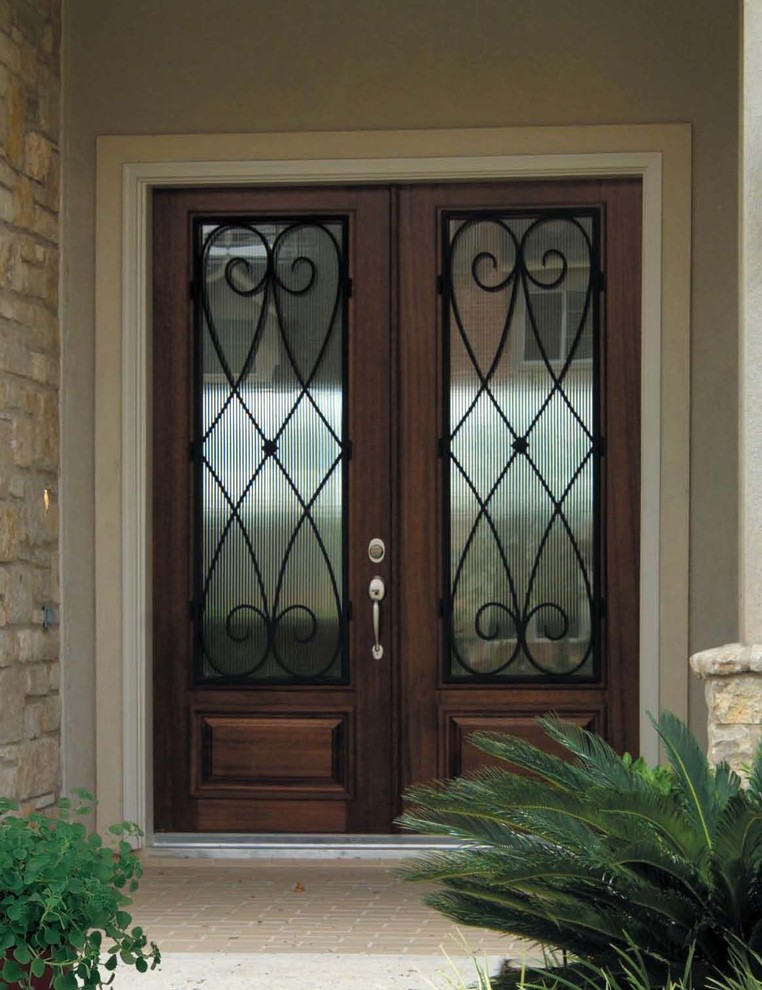 Inspiration for a large mediterranean front door in Tampa with a double front door and a dark wood front door.