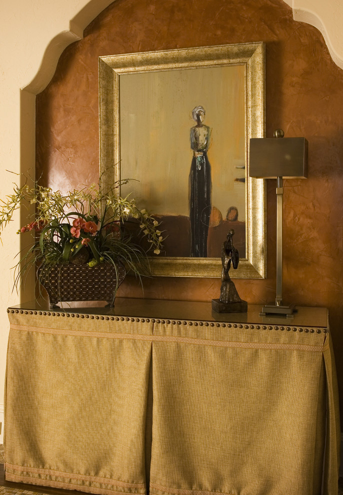 Inspiration for a mediterranean entrance in Orlando with brown walls and feature lighting.