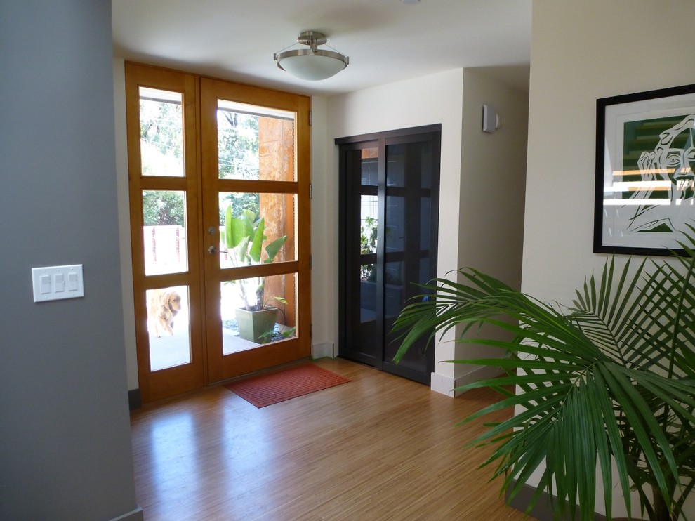Mid-sized trendy entryway photo in San Francisco with white walls and a medium wood front door