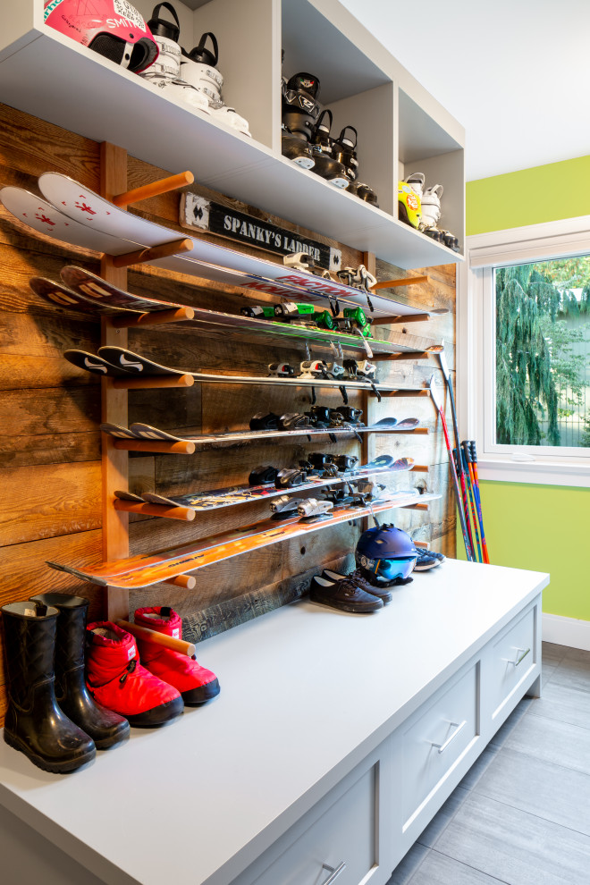 Photo of a large contemporary boot room in Vancouver with porcelain flooring, green walls and grey floors.