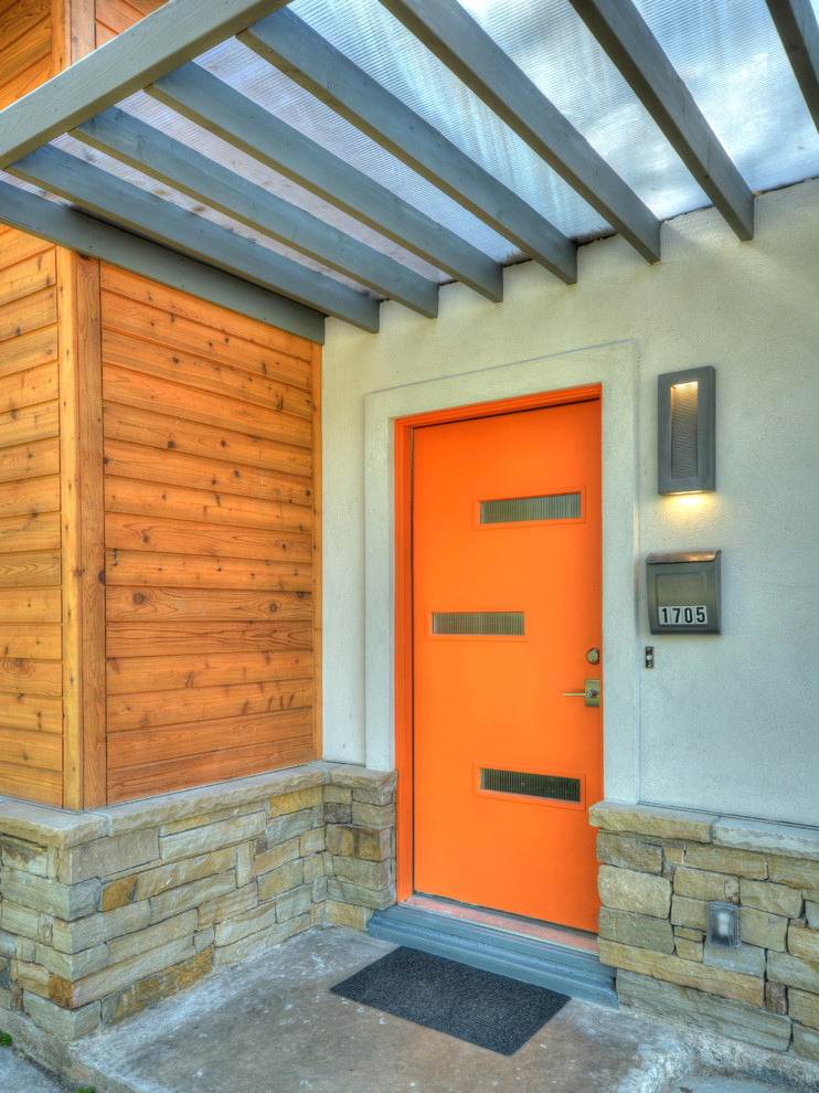 Design ideas for a medium sized contemporary front door in Austin with a single front door and an orange front door.