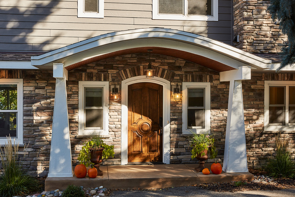 Expansive traditional front door in Minneapolis with a single front door and a medium wood front door.