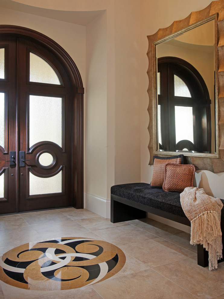 Inspiration for a traditional entrance in Miami with beige walls and beige floors.