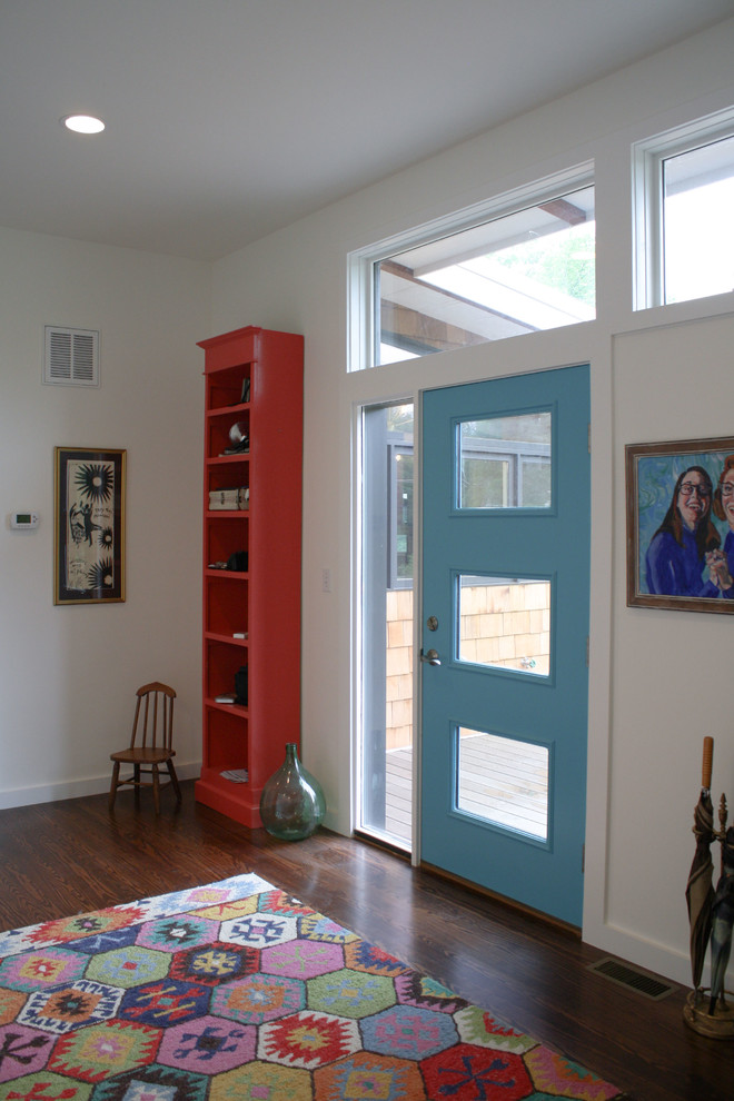 Photo of a medium sized retro boot room in Philadelphia with white walls, dark hardwood flooring and a blue front door.