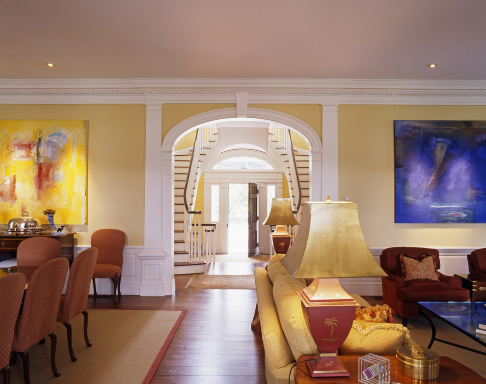 Inspiration for a large traditional entrance in Charlotte with yellow walls and dark hardwood flooring.