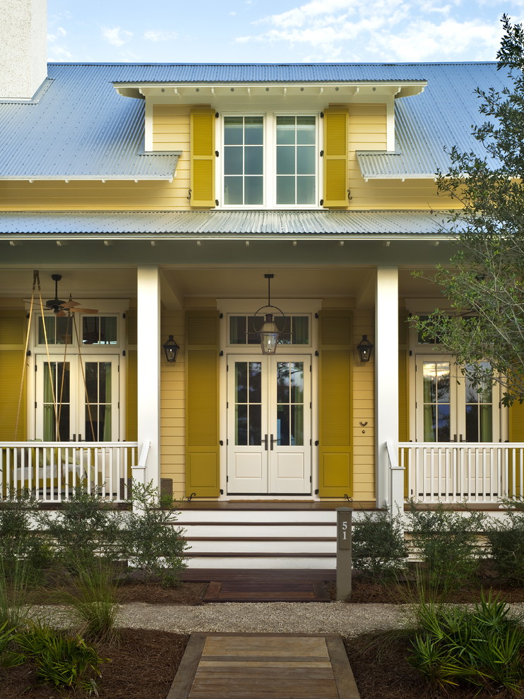 Photo of a country porch in Miami with a double front door, a white front door and feature lighting.