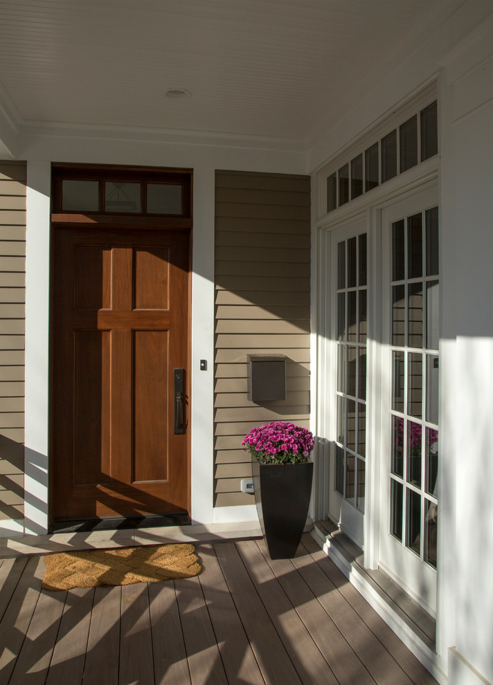 Idée de décoration pour une porte d'entrée champêtre de taille moyenne avec un mur beige, un sol en vinyl, une porte simple et une porte en bois brun.