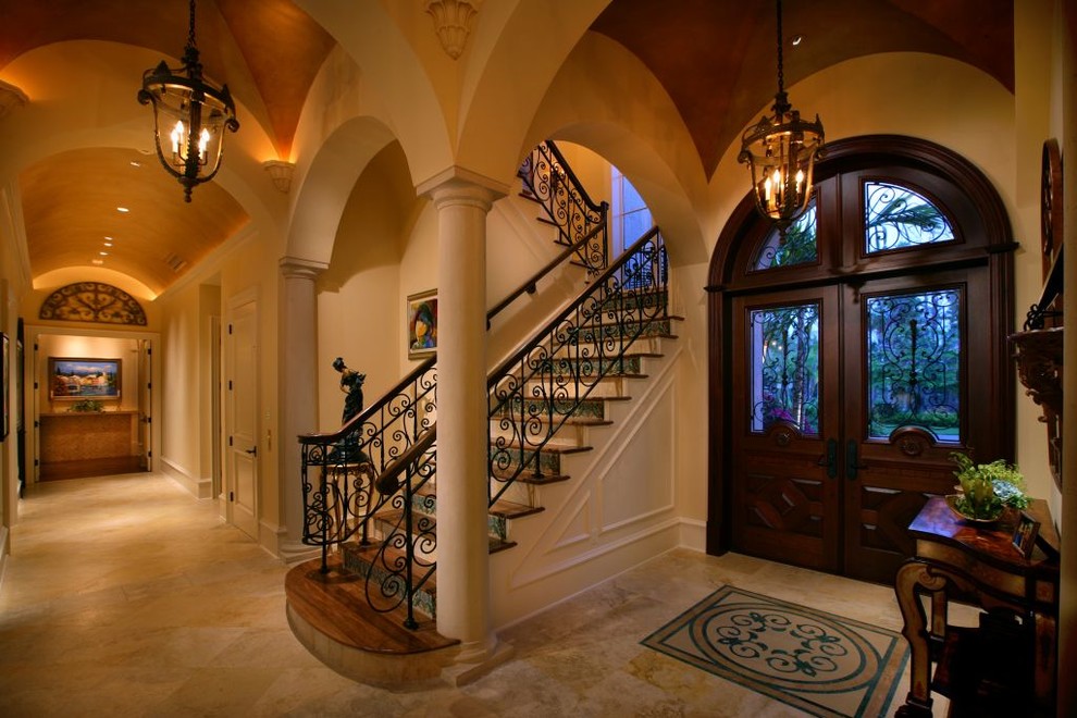Photo of a mediterranean entrance in Miami with beige walls, a double front door and beige floors.