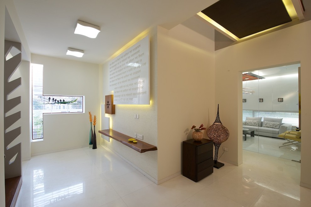 Inspiration for a contemporary white floor entryway remodel in Ahmedabad with beige walls