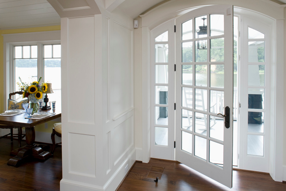 Large elegant medium tone wood floor entryway photo in Baltimore with white walls and a glass front door