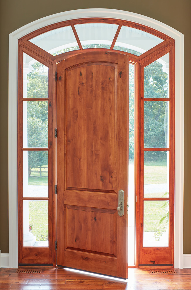 Immagine di una porta d'ingresso country con pareti verdi, parquet scuro, una porta singola e una porta in legno bruno