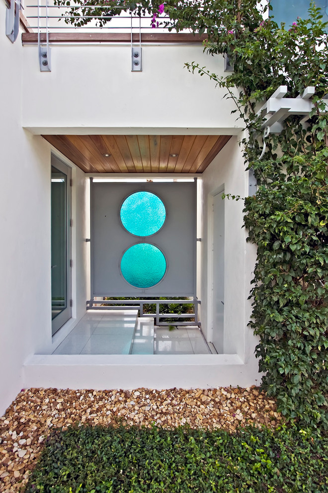 Inspiration for a world-inspired front door in Miami with a single front door and a glass front door.