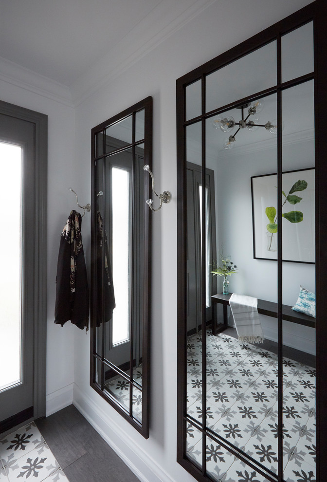 Inspiration for a modern foyer in Toronto with white walls, ceramic flooring, a single front door, a dark wood front door and white floors.