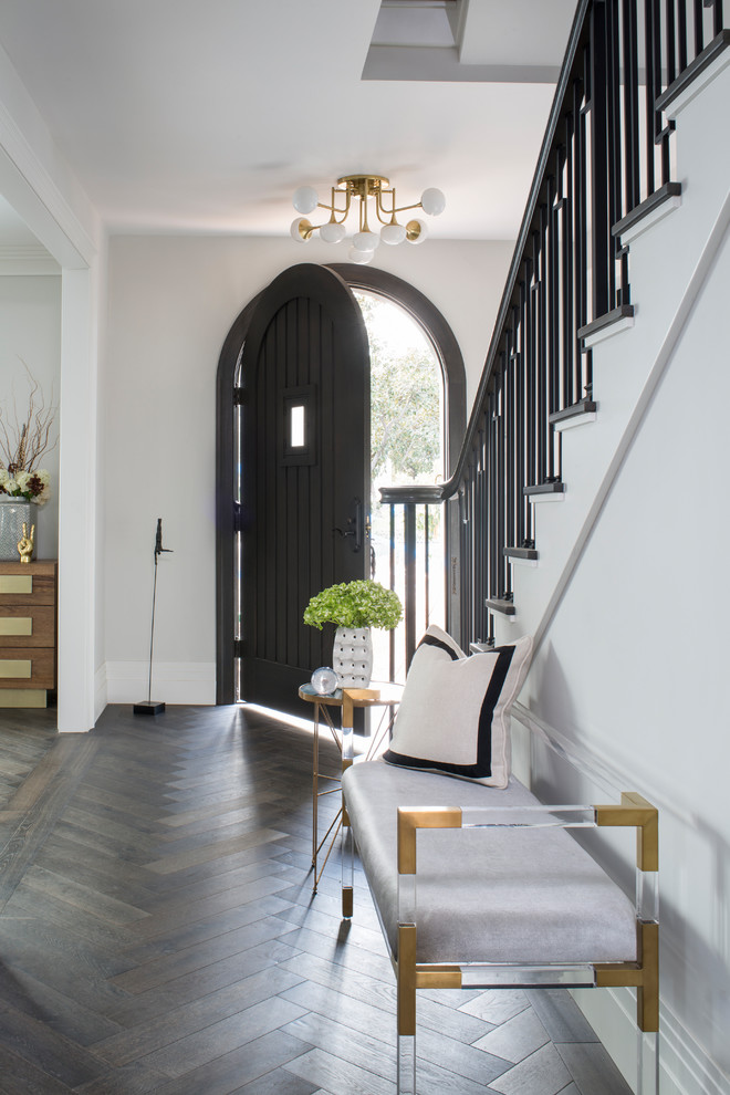 Inspiration for a mid-sized transitional medium tone wood floor and brown floor entryway remodel in Los Angeles with gray walls and a brown front door