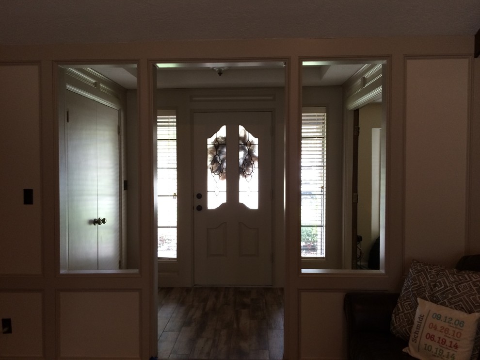 Medium sized contemporary front door in Houston with beige walls and medium hardwood flooring.