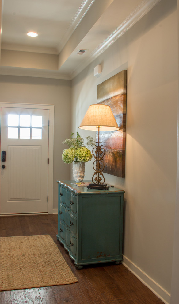 Entryway - mid-sized transitional dark wood floor entryway idea in Birmingham with gray walls and a white front door