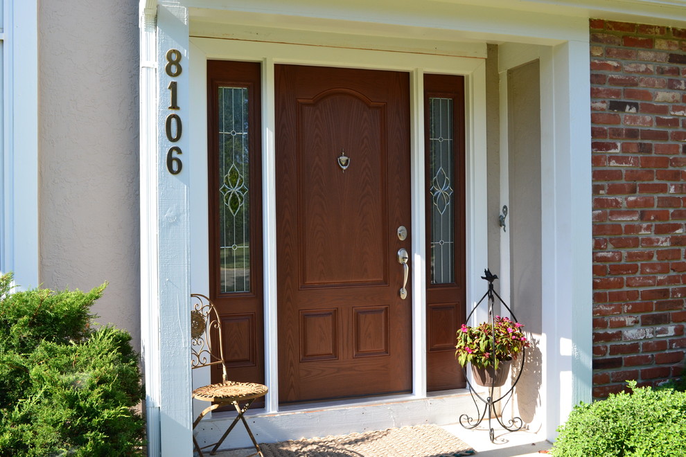Elegant single front door photo in Kansas City with a medium wood front door and beige walls