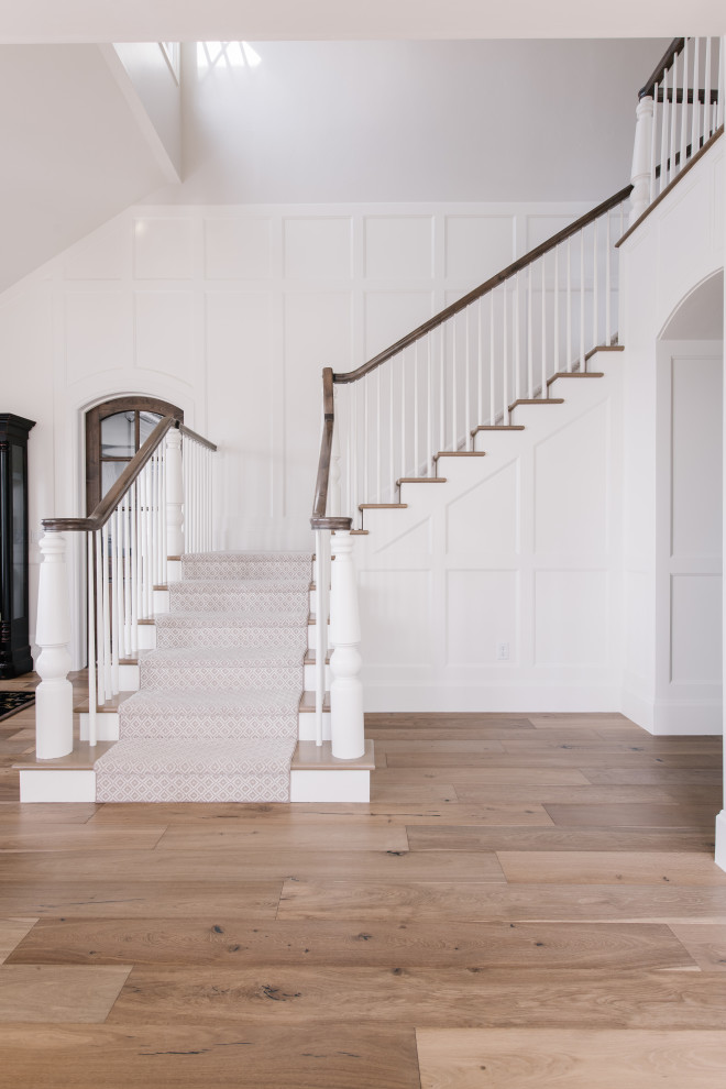 Example of a mid-sized transitional wainscoting staircase design in Salt Lake City