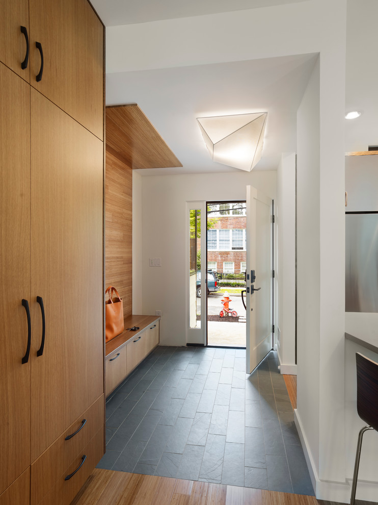 Mudroom - contemporary slate floor and gray floor mudroom idea in New York with white walls