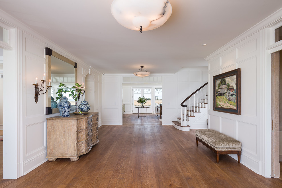 Inspiration for a coastal medium tone wood floor foyer remodel in Los Angeles with white walls