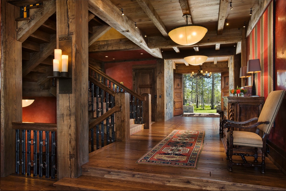 Design ideas for a rustic entrance in Other with red walls and feature lighting.