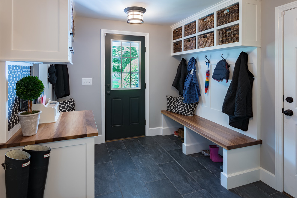 Example of an eclectic slate floor and gray floor entryway design in Boston with gray walls and a black front door