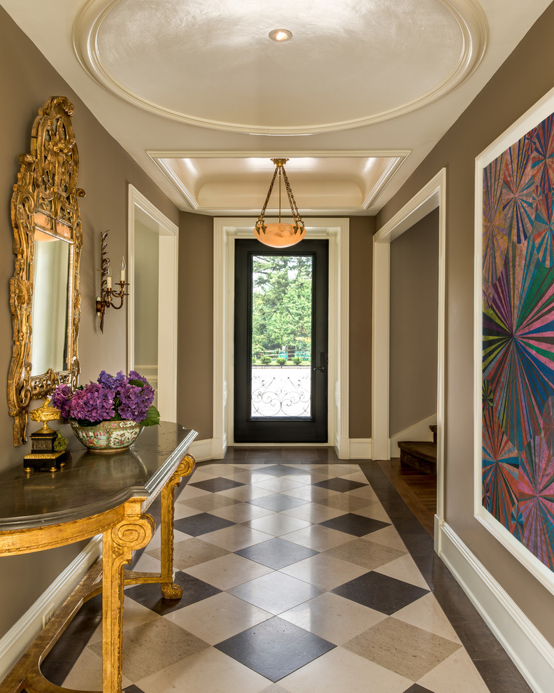 Idée de décoration pour une grande entrée tradition avec un couloir, un mur marron, une porte simple, une porte en verre et un sol multicolore.