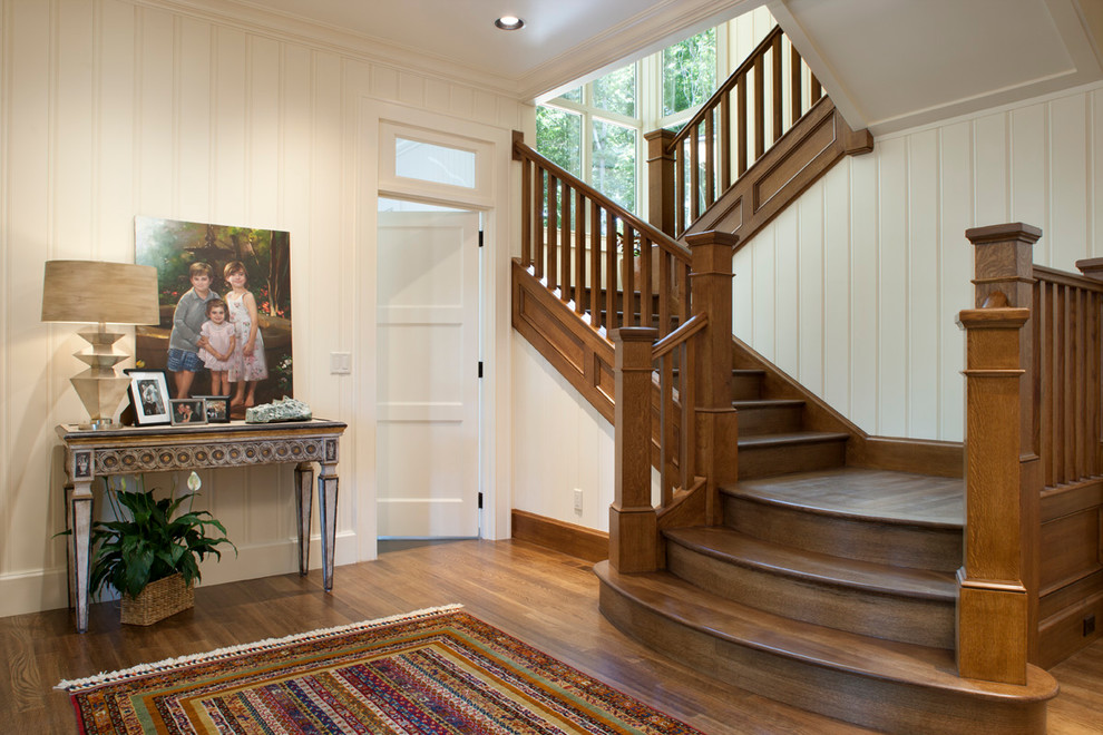 Medium sized classic foyer in Other with white walls, medium hardwood flooring, a single front door and feature lighting.